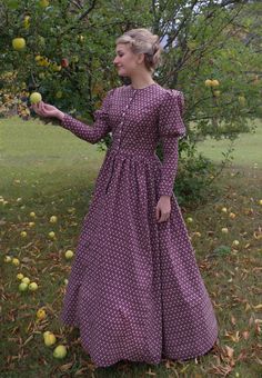 This charming dress has a jewel neckline, front button closure and leg-o-mutton long sleeves. The fitted bodice has a full skirt gathered at the waist. This dress also features our three-paneled full skirt with pockets. Hand wash or machine wash and dry gently. 100% sturdy cotton. The model is wearing boots and a crinoline, which are priced separately. Designed and made proudly by Recollections in America! The following are approximate finished measurements and include room for ease of movement. Prairie Dresses Carolyn Ingals, Long Sleeve Dresses With Gathered Sleeves For Garden Party, Fall Dresses With Gathered Skirt, Fall Dresses With Gathered Full Skirt, Fall Dresses With Full Gathered Skirt, Long Sleeve Gathered Skirt Fall Dress, Long Sleeve Dress With Gathered Skirt For Fall, Long Sleeve Prairie Dress For Fall Garden Party, Long Sleeve Prairie Dress For Daywear