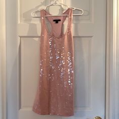 a pink dress hanging on a white door