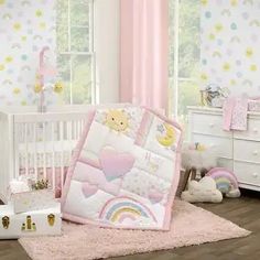 a baby crib bedding set with teddy bears and rainbows on the wall