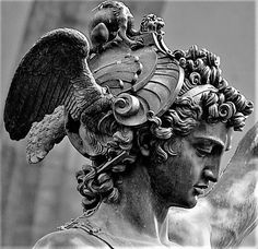 a statue with an eagle on top of it's head in black and white