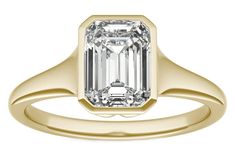 an emerald - cut diamond ring set in yellow gold