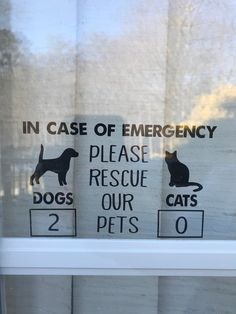 there are two signs on the window saying in case of emergency please rescue our pets