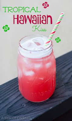 a pink drink in a mason jar with a striped straw on the top and tropical hawaiian kiss logo above it