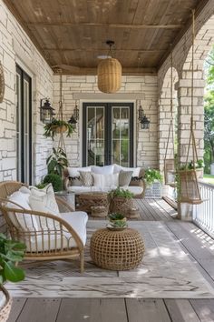 a porch with wicker furniture and hanging plants