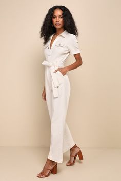 If you want to stay comfortable while looking cute, then the Lulus Practical Perfection Ivory Twill Short Sleeve Jumpsuit was made for you! Slightly stretchy woven twill shapes this trendy jumpsuit that has a collared neckline framed by short cuffed sleeves. Bodice has decorative, twin pocket flaps at the front with a functional button placket. Fitted waist features belt loops, a tying sash belt, and a hidden zip fly, all atop straight pant legs with diagonal side pockets and ankle-length hems. Chic Cotton Jumpsuits For Work, Chic Cotton Jumpsuits And Rompers For Work, Cream Jumpsuits And Rompers With Pockets For Summer, White Cotton V-neck Jumpsuit, White Cotton V-neck Jumpsuits And Rompers, Chic Fitted Jumpsuits And Rompers With Pockets, Neutral Casual Jumpsuits And Rompers For Summer, Neutral Summer Casual Jumpsuits And Rompers, Elegant Relaxed Fit Jumpsuit In Solid Color