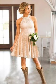 a beautiful woman in a short dress and cowboy boots posing for the camera with her bouquet