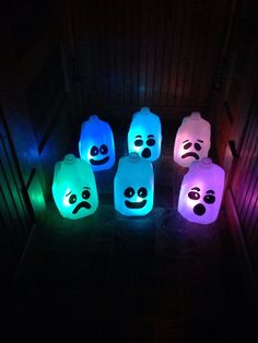 glowing lanterns in the dark with faces on them