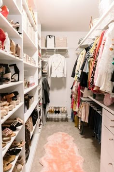 an organized closet with white shelving and lots of shoes