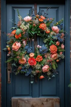 a blue front door with a wreath on it