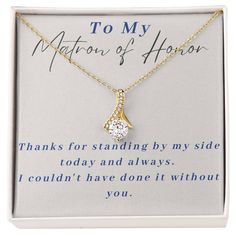 a gold necklace with a white diamond in the center and an inscription on it that says to my matron of honor