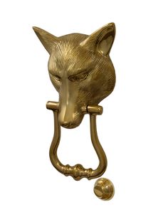 a gold colored metal door handle with a cat's head on the back of it