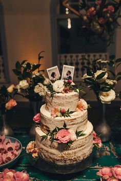 there is a wedding cake with flowers on the table next to other cakes and desserts