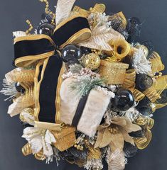 a wreath with black, gold and white decorations