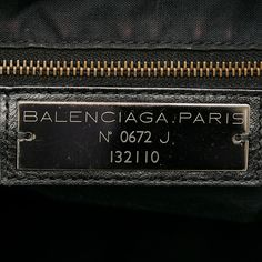 Founded in San Sebastian, Spain in 1918, the House of Balenciaga relocated to Paris in 1937 during the Spanish Civil war. Almost immediately Cristóbal was hailed as 'the couturier of couturiers.' Past designer Nicolas Ghesquiere, had revitalized the company with a youthful aesthetic, introducing the famous motorcycle inspired handbags. Successor to Alexander Wang, current Creative Director Demna Gvasalia upholds the brand’s rejuvenating aesthetic with high-fashion streetwear and graphic-driven s Luxury Logo Plaque Shoulder Bag For Travel, Luxury Shoulder Bag With Logo Plaque For Travel, Leather Shoulder Bag With Logo Plaque For Travel, Travel Leather Shoulder Bag With Logo Plaque, Luxury Travel Shoulder Bag With Logo Plaque, Pre-owned Classic Business Shoulder Bag, Classic Pre-owned Business Shoulder Bag, Rectangular Travel Bag With Logo Plaque, Designer Travel Shoulder Bag With Engraved Logo