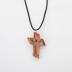 This Christian Necklace with Cross is an ideal gift for Catholics of all ages. Its handmade olive wood from the Holy Land creates a timeless and meaningful piece of faith jewelry that your recipient will cherish. The artisans are Christian, meaning your purchase will help support their work. This is a meaningful gift that's sure to inspire. Dimensions: L 1.2" x W 0.2" x H 1.6" Description: Small and yet boundless this cross represents all the faith you feel. Made from the finest olive wood in Be Olive Wood Cross, Cross Necklaces, Christian Necklace, Faith Jewelry, Wood Cross, Wood Spoon, Wood Crosses, Holy Land, Bethlehem