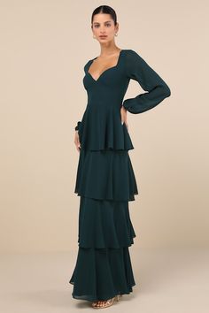 The Lulus Flawless Excellence Emerald Tiered Long Sleeve Maxi Dress was made to take everyone's breath away! This luxe dress has a lightweight woven chiffon composition that shapes princess-seamed cups, a V-neckline (and V-back), and slightly sheer, balloon-style long sleeves with elastic at the cuffs. The flattering, set-in waist tops a tiered, A-line skirt that falls to a sweeping maxi hem. A slender tying strap secures at the back, atop a hidden back zipper/clasp. Fit: This garment fits true Fitted Tiered Chiffon Dress With Ruffles, Fitted Chiffon Dress With Tiered Ruffles, Wedding Dress With Pleated Bodice And Tiered Shape, Fitted Tiered Chiffon Dress, Flowy Tiered Lined Dress, Fitted Green Tiered Dress, Fitted Green Chiffon Long Sleeve Dress, Fitted Long Sleeve Green Chiffon Dress, Green Fitted Long Sleeve Chiffon Dress