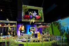 a large room filled with lots of tables covered in flowers and chairs next to each other