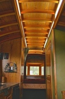 the inside of a house with wood paneling on the ceiling and counter top area