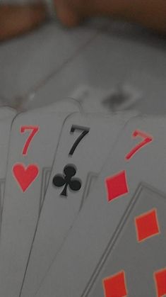 playing cards are arranged in the shape of fours and sevens on a table