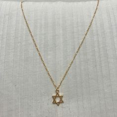 A beautiful and dainty Goldfilled Star of David Necklace.  The chain is goldfield and the Star of David is Gold plated with high-quality 2-micron gold. The Star of David (also known as "Magen David" or "Shield of David") is an ancient Jewish symbol that is known from the holy bible and known as a symbol for self-protection. A beautiful piece to add to your personal collection or to give as a special gift. ❤𝗠𝗘𝗔𝗦𝗨𝗥𝗘𝗠𝗘𝗡𝗧𝗦 ❤ Pendant length: 0.47" / 1.2 cm Pendant with: 0.47" / 1.2 cm Made of high-quality 24k gold plated brass. Please choose your preferred length from the list above. ❤ 𝗠𝗬 𝗦𝗧𝗢𝗥𝗘 ❤ Feel free to take a look at my shop (below) for more beautiful items and inspiration. Back to my shop:  https://etsy.me/2ZBJCus ❤ 𝗔𝗕𝗢𝗨𝗧 𝗠𝗬 𝗟𝗜𝗧𝗧𝗟𝗘 𝗦𝗧𝗢𝗥𝗘 ❤ *If you ha Gold Star Of David Charm Necklace With Delicate Chain, Dainty Star Of David Necklace With Adjustable Chain, Gold Star Of David Charm Necklace As Gift, Gold Star Of David Charm Necklace For Gift, Gold Minimalist Star Of David Charm Necklace, Minimalist Gold Necklace With Star Of David, Gold Star Of David Spiritual Necklace, Gold Star-shaped Charm Necklace With Adjustable Chain, Gold Star Charm Necklace With Adjustable Chain