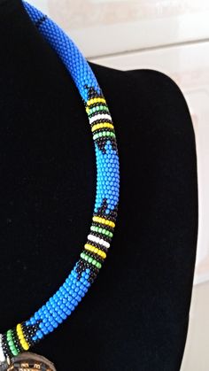 African Pendant Necklace, African Pendant Jewelry, African Beaded Necklace, Zulu Beaded Necklace, Bush Blue Necklace, Gift For Her This stunning pendant necklace is superbly crafted which makes you stands out in any occasion. Main Color - Bush Blue. Different colors of your choice can be available. Wholesale available at a fair price. For any query please send me a convo or an e-mail. Happy Shopping Blue And Black Beads Bohemian Necklace, Traditional Blue Necklaces With Tiny Beads, Traditional Blue Necklace With Tiny Beads, Bohemian Blue And Black Beaded Necklaces, Blue Jewelry With Round Black Beads, Blue Beaded Chain Beads As Gift, Handmade Blue Beads For Jewelry Making, Blue Beaded Chain Beads For Gift, Adjustable Blue Beaded Necklace With Large Beads