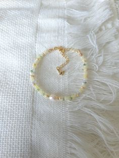 FOR OTHER DAINTY BEADED BRACELETS: https://www.etsy.com/ca/shop/ArtiChouXCanada?ref=seller-platform-mcnav%C2%A7ion_id&section_id=46088511 Bracelet Length: 13-18cm (5.1-7 inches) with a 14k gold filled extender.  This bracelet features an assortment of pastel colors: yellow, green, cream, white, and 18k gold filled seed beads. It also contains a freshwater pearl.  Thread may be visible since it is a handmade product   SIZING  Wrap a soft measuring tape snugly around the widest part of your wrist. Cheap Yellow Bracelets With Tiny Beads, Cheap Dainty Hand-strung Beaded Bracelets, Cheap Hand-strung Dainty Beaded Bracelet, Cheap Cute Yellow Beaded Bracelets, Pastel Colors Yellow, Tiny Bead Bracelet, Pearl Bracelet Gold, Yellow Pastel, Diy Bracelets Patterns