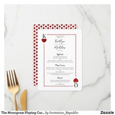 a red and white wedding card with hearts on it, sitting next to a knife and fork