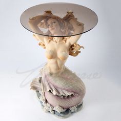 a glass table with a mermaid on it