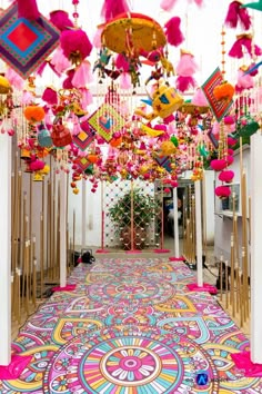 a colorful carpet with lots of tassels hanging from it's ceiling and some decorations on the floor