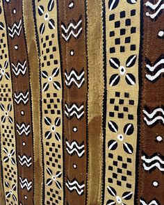 a group of brown and white cloths hanging on a wall next to each other