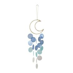 a wind chime hanging from the side of a white wall with blue and grey circles