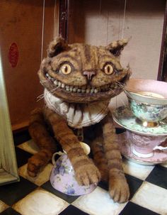 a creepy looking cat sitting on top of a black and white checkered floor