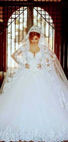 a woman in a white wedding dress and veil