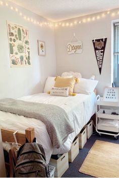 a bedroom with white walls and string lights