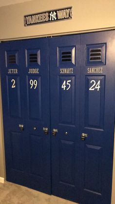 three blue doors with numbers on them in a room that says yankee's k way