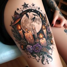 a woman's thigh with candles and stars on it, in front of a full moon