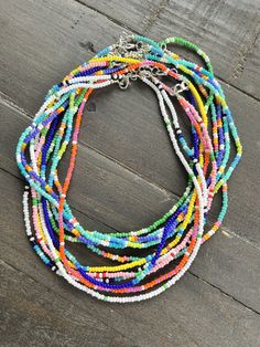 Adjustable Multicolor Beaded Strand Necklace, Adjustable Multicolor Beaded Strand Necklaces, Multicolor Beaded Chain Strand Beads, Festival Beaded Necklace With Tiny Beads Strand, Summer Beaded Necklaces With Round Letter Beads, Tiny Beads Strand For Festival, Festival Beaded Strand Necklace With Tiny Beads, Summer Beaded Necklace With Tiny Beads, Casual Multicolor Beaded Necklaces With Tiny Beads