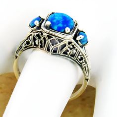 Vintage Estate Three Stone Blue Lab-Created Fire Opal Filigree Ring. 925 Solid Sterling Silver. Stamped 925.  Excellent Condition/Like New. Classic Blue Opal Ring As A Gift, Classic Blue Opal Ring As Gift, Classic Blue Opal Ring For Gift, Classic Blue Opal Ring Gift, Classic Blue Opal Round Ring, Classic Blue Opal Ring For Anniversary, Blue Hallmarked Opal Ring For Wedding, Elegant Blue Opal Ring Stamped 925, Vintage Blue Opal Ring For Anniversary