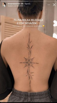 the back of a woman's neck with flowers on it