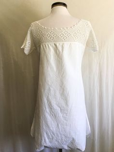 "Beautiful antique Edwardian romper with button crotch and beautiful crochet lace yoke. ~lightweight cotton ~crochet lace ~button crotch ❉ measurements: Measured Flat bust: 37\" waist:44\" length: 33.5\" from high point shoulder to hem end of sleeve to other end of sleeve: 27.5\" brand/maker:N/A material:cotton, crochet lace condition: Great ❉ All items are vintage and have been worn and loved, some small flaws may go unnoticed. I promise to include every detail of every garment accurately." Cotton Crochet Dress For Daywear, Cottagecore Lace Trim Dress For Loungewear, Cottagecore Dress With Lace Trim For Loungewear, Summer Crochet Dress With Lace Trim For Daywear, Cottagecore Lounge Dress With Lace Trim, Fitted Cotton Lace Dress With Crochet Trim, White Crochet Dress With Lace Trim For Daywear, Fitted Dress With Crochet Trim In Cotton Lace, Short Sleeve Lace Dresses With Crochet Trim