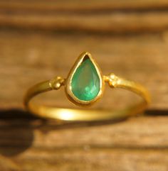 emerald drop gold ring//artisan emerald ring//emerald 24k gold ring//emerald ring//24k gold ring//emerald gold ring//24k gold earring emeralds are one of my favorite gem to work with, seeing them on screen amazes me. It's a true one of kind.  The stone is drop emerald 8x5 mm.  (0.35"x0.2")                      I used 24k gold for the setting and 22k for the rest of the wire (shank) ring (1.4 mm wire) I have done matching studs, and i can make a matching pendant/bracelet. with any custom order yo Dainty Gold Emerald Ring For May Birthstone, 22k Gold Green Jewelry For Anniversary, Teardrop Emerald Ring In Yellow Gold, Green 22k Gold Jewelry For Anniversary, Gold Teardrop Emerald Ring, Handmade Yellow Gold Emerald Ring, Handmade Fine Jewelry Emerald Ring In Yellow Gold, Handmade Emerald Ring In Yellow Gold, Fine Jewelry Style, Teardrop Emerald Ring As Gift