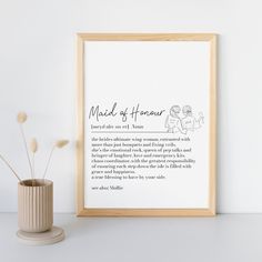 a framed print with the words made of paper next to a potted plant