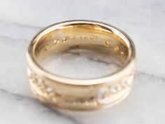 This engraved band is of a perfect heft and shape to feel soft and pleasant on the finger. It is both pretty and sophisticated, and it would be a great wedding or stacking band for a woman who wants a little extra sparkle but works with her hands. Metal: 18K Yellow Gold Gem: 12 Diamonds totaling .36 Carats, F in Color, VVS in Clarity Width of Band: 6.5 mm Height off Finger: 1.9 mm Ring Size: 6 Marks: "AA18K" Stamped on the inside band Luxury Vintage Gold Bands, Heirloom Yellow Gold Thick Band Stackable Rings, Luxury Yellow Gold Thick Band Engraved Ring, Luxury Yellow Gold Band With Intricate Design, Luxury 14k Gold Wedding Band With Decorative Details, Gold Diamond Band, Stacking Bands, Cameo Ring, Diamond Anniversary