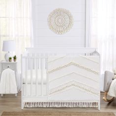 a white crib bedding set in a baby's room