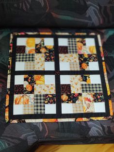 a quilted table runner with pumpkins on it