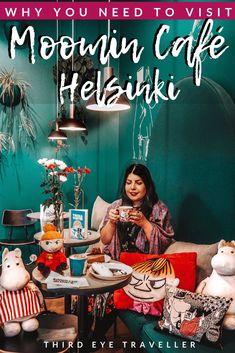 a woman sitting at a table with stuffed animals on it and the words, why you need to visit mountain cafe helsukki