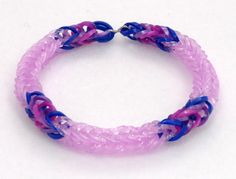 a pink and blue bracelet with silver clasps on a white background, it looks like something out of space