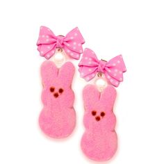 two pink bunny ear clips with bows on them