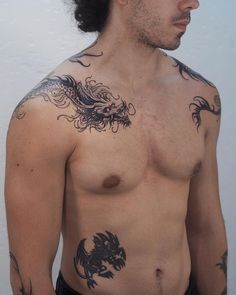 a shirtless man with tattoos on his chest