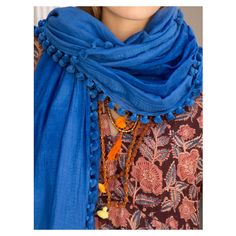 Our popular dupatta is inspired by the original Indian scarves. Perfect for travel, this versatile wrap can be styled as a sarong or wrapped around your shoulders as a shawl. Threads of cotton and silk are hand spun and then set and woven on looms, resulting in a luxurious and lightweight fabric. It takes a few days to weave one piece and when it's done, an average of 320 tassels are tied by hand on all four sides. 50% Cotton 50% Silk Approximately 100 x 200 cm Please handle with care: hand wash Bohemian Cotton Sheer Dupatta, Bohemian Cotton Scarves One Size, Bohemian Indigo Cotton Dupatta, Bohemian Blue Handloom Dupatta, Bohemian Shawl Scarf With Natural Dye, Bohemian Shawl Scarves With Natural Dye, Traditional Shawl Scarves For Beach, Bohemian Dupatta Shawl, Bohemian Sheer Dupatta Shawl